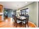 Inviting dining room with hardwood floors and a large window offering scenic outdoor views at 10895 Pheasant Run, Littleton, CO 80125