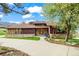 Charming home featuring wood siding, stone accents, a tile roof, and a beautifully landscaped front yard at 10895 Pheasant Run, Littleton, CO 80125