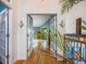 Inviting hallway with hardwood floors and decorative lighting, leading to sunlit rooms at 10895 Pheasant Run, Littleton, CO 80125