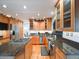 Spacious kitchen featuring stainless steel appliances, wood cabinets, and granite countertops at 10895 Pheasant Run, Littleton, CO 80125