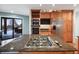Bright kitchen with a gas cooktop island, stainless steel appliances, and wood cabinets at 10895 Pheasant Run, Littleton, CO 80125