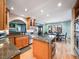 Open-concept kitchen with granite countertops, stainless steel appliances, and breakfast bar seating at 10895 Pheasant Run, Littleton, CO 80125