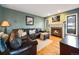 Comfortable living room with a fireplace, plush seating, and warm lighting at 10895 Pheasant Run, Littleton, CO 80125