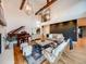 Elegant living room featuring vaulted ceilings, statement lighting, cozy seating and a grand piano at 10895 Pheasant Run, Littleton, CO 80125