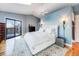 A main bedroom with a vaulted ceiling, blue walls, and a balcony at 10895 Pheasant Run, Littleton, CO 80125