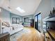 Bright main bedroom with a skylight, light blue walls, and a sliding glass door to a balcony with views at 10895 Pheasant Run, Littleton, CO 80125