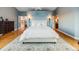 A main bedroom features a large rug and ensuite bath at 10895 Pheasant Run, Littleton, CO 80125