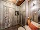 Rustic mudroom with wood paneling, a bench, and storage cabinets at 10895 Pheasant Run, Littleton, CO 80125