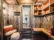 Rustic mudroom featuring wooden accents, built-in storage, and bench seating at 10895 Pheasant Run, Littleton, CO 80125