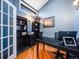 Home office featuring hardwood floors, a modern desk, bookshelves, and natural light at 10895 Pheasant Run, Littleton, CO 80125