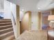 Carpeted staircase with wooden railing leading to the upper level of the house at 10895 Pheasant Run, Littleton, CO 80125