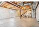 Unfinished basement with exposed ceiling beams and staircase, providing ample space for future living areas at 1557 S Dallas Cir, Denver, CO 80247