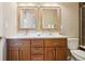 Charming bathroom featuring a double vanity, framed mirrors, and ample storage space for toiletries at 1557 S Dallas Cir, Denver, CO 80247