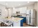Eat in kitchen with granite island, stainless steel appliances, and modern cabinetry at 1557 S Dallas Cir, Denver, CO 80247