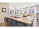 Close-up of a kitchen island with granite countertop, faucet, and cabinets at 1557 S Dallas Cir, Denver, CO 80247