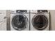 Modern, front-loading washer and dryer set in a well-lit laundry room, offering convenience and efficiency at 1557 S Dallas Cir, Denver, CO 80247