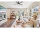 Bright, airy living room featuring a modern fireplace, hardwood floors, and ample natural light at 1557 S Dallas Cir, Denver, CO 80247