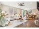 Open-concept living area with hardwood floors, modern furniture, and seamless flow to dining space at 1557 S Dallas Cir, Denver, CO 80247
