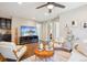 Comfortable living room offers an entertainment center and adjacent wet bar at 1557 S Dallas Cir, Denver, CO 80247