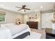 Spacious main bedroom with a ceiling fan, dresser, and a walk-in closet door for organized storage at 1557 S Dallas Cir, Denver, CO 80247