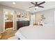 Inviting main bedroom with a ceiling fan, stylish dresser, and an ensuite bathroom for added convenience at 1557 S Dallas Cir, Denver, CO 80247
