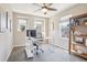 Bright home office with a ceiling fan, two windows, and stylish desk and shelving at 1557 S Dallas Cir, Denver, CO 80247