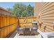 Private patio featuring outdoor seating, wooden fencing, and a stylish rug for comfortable outdoor living at 1557 S Dallas Cir, Denver, CO 80247