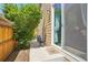 Small backyard patio with a sliding glass door entry and a small garden area at 1557 S Dallas Cir, Denver, CO 80247