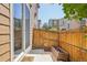 Cozy patio with wood fence, concrete pad, and sliding door, ideal for outdoor dining and relaxation at 1557 S Dallas Cir, Denver, CO 80247