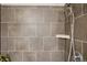 Close-up of a modern shower with sleek tile design and a contemporary showerhead for a relaxing experience at 1557 S Dallas Cir, Denver, CO 80247