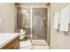 Modern shower with stylish tile work, glass enclosure, and a rainfall showerhead for a luxurious experience at 1557 S Dallas Cir, Denver, CO 80247