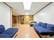 Spacious basement rec room with wood accents and comfortable blue seating at 1341 S Blackhawk Way, Aurora, CO 80012
