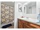 Traditional bathroom features a wood vanity and a shower/tub combo with a decorative curtain at 1341 S Blackhawk Way, Aurora, CO 80012