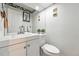 Cozy half-bathroom with a white vanity, mirror, and toilet at 1341 S Blackhawk Way, Aurora, CO 80012