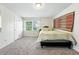 Sunlit bedroom with plush carpeting, a comfortable bed, and ample natural light at 1341 S Blackhawk Way, Aurora, CO 80012