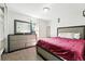 This bedroom has a nice dresser and a large bed with red covers at 1341 S Blackhawk Way, Aurora, CO 80012