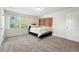 Comfortable bedroom with a large window, neutral carpeting, and decorative wall hanging at 1341 S Blackhawk Way, Aurora, CO 80012