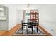 Bright dining room with hardwood floors, classic china cabinet, and seating for four at 1341 S Blackhawk Way, Aurora, CO 80012