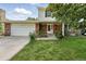 Charming brick home featuring an attached garage and a well-manicured front yard at 1341 S Blackhawk Way, Aurora, CO 80012