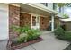 Close-up view of a welcoming front porch with red brick and a decorative white front door at 1341 S Blackhawk Way, Aurora, CO 80012
