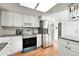 Updated kitchen featuring stainless steel appliances, granite countertops, and white cabinetry at 1341 S Blackhawk Way, Aurora, CO 80012