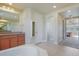 Bright bathroom featuring a modern corner tub, and double vanity sinks with granite countertops at 10003 Atlanta St, Parker, CO 80134