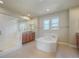 Spacious bathroom with a corner tub, glass-enclosed shower, and double vanity sinks at 10003 Atlanta St, Parker, CO 80134