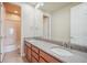 Bathroom featuring a double vanity, a large mirror, and a separate toilet and shower area at 10003 Atlanta St, Parker, CO 80134