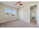 Carpeted bedroom with neighborhood views and adjacent hallway at 10003 Atlanta St, Parker, CO 80134