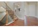 Inviting entryway with hardwood floors, staircase with wrought iron railing, and bright, open design at 10003 Atlanta St, Parker, CO 80134