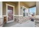 Inviting front porch with stone accents, decorative welcome sign, and covered entrance for guests at 10003 Atlanta St, Parker, CO 80134