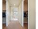 Hallway leading to a bright bathroom and featuring two walk-in closets with ample storage space at 10003 Atlanta St, Parker, CO 80134