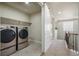 Convenient laundry room featuring side-by-side washer and dryer units and easy access to the hall at 10003 Atlanta St, Parker, CO 80134