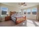 Bedroom featuring a large wood frame bed, matching nightstands, and plenty of natural light at 10003 Atlanta St, Parker, CO 80134